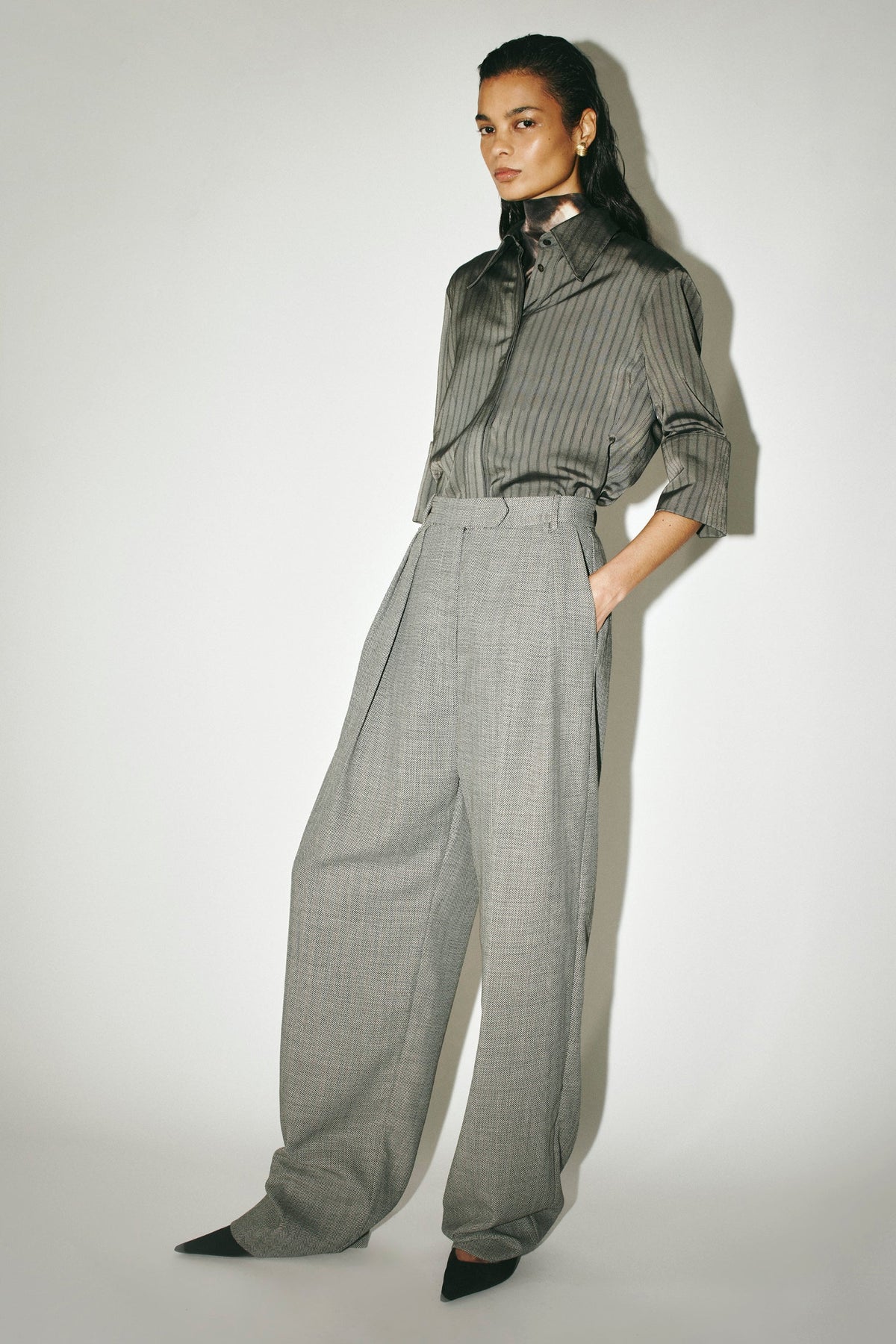 Three-quarter view CAMILLA AND MARC Ren Pant in Charcoal Herringbone styled with the Mina Short Sleeve Shirt.