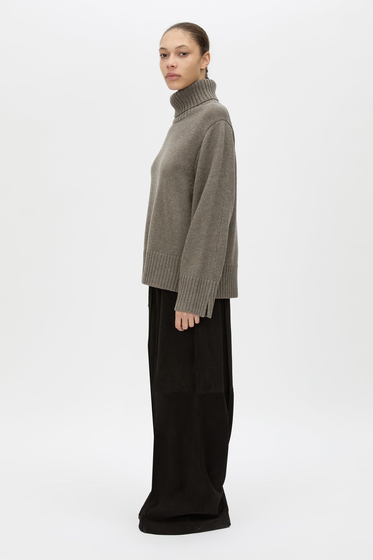 Side view CAMILLA AND MARC Crawford Knit Roll Neck Sweater in Grey with wool knit finish and roll‑neck silhouette.