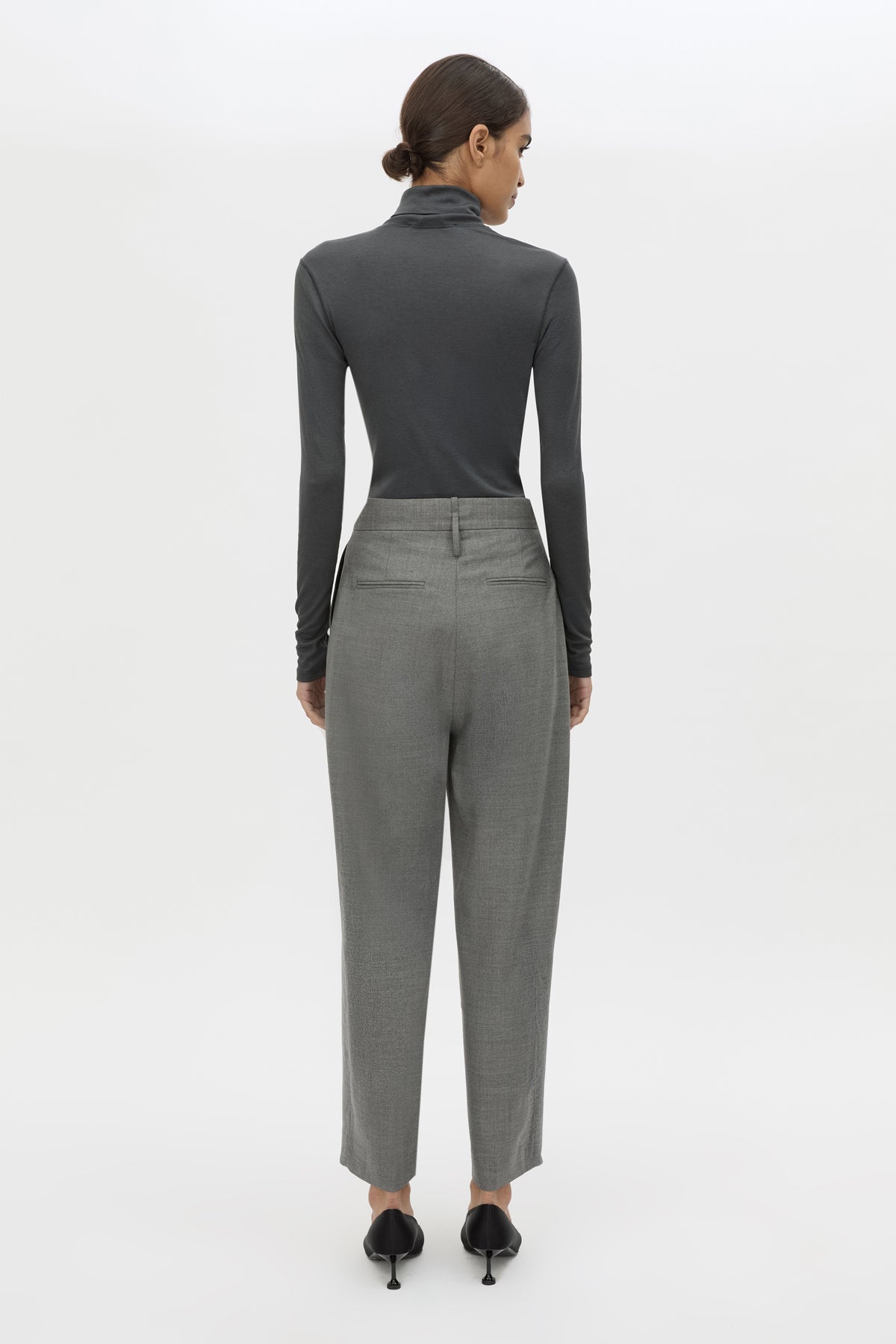 Back view CAMILLA AND MARC Barre High Neck Top in Charcoal Grey with long sleeves and V‑neck split turtleneck.