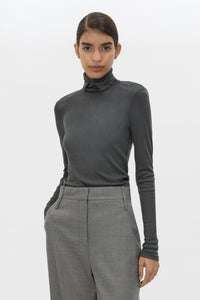 Cropped view CAMILLA AND MARC Barre High Neck Top in Charcoal Grey with long sleeves and V‑neck split turtleneck.