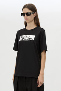 Cropped view CAMILLA AND MARC Carmont Graphic Tee in Black with white graphic logo.
