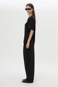 Side view CAMILLA AND MARC Carmont Graphic Tee in Black with white graphic logo.