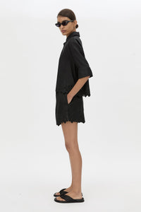 Side view CAMILLA AND MARC Chara Embroidered Short in black with embroidered hem and elasticated waistband.