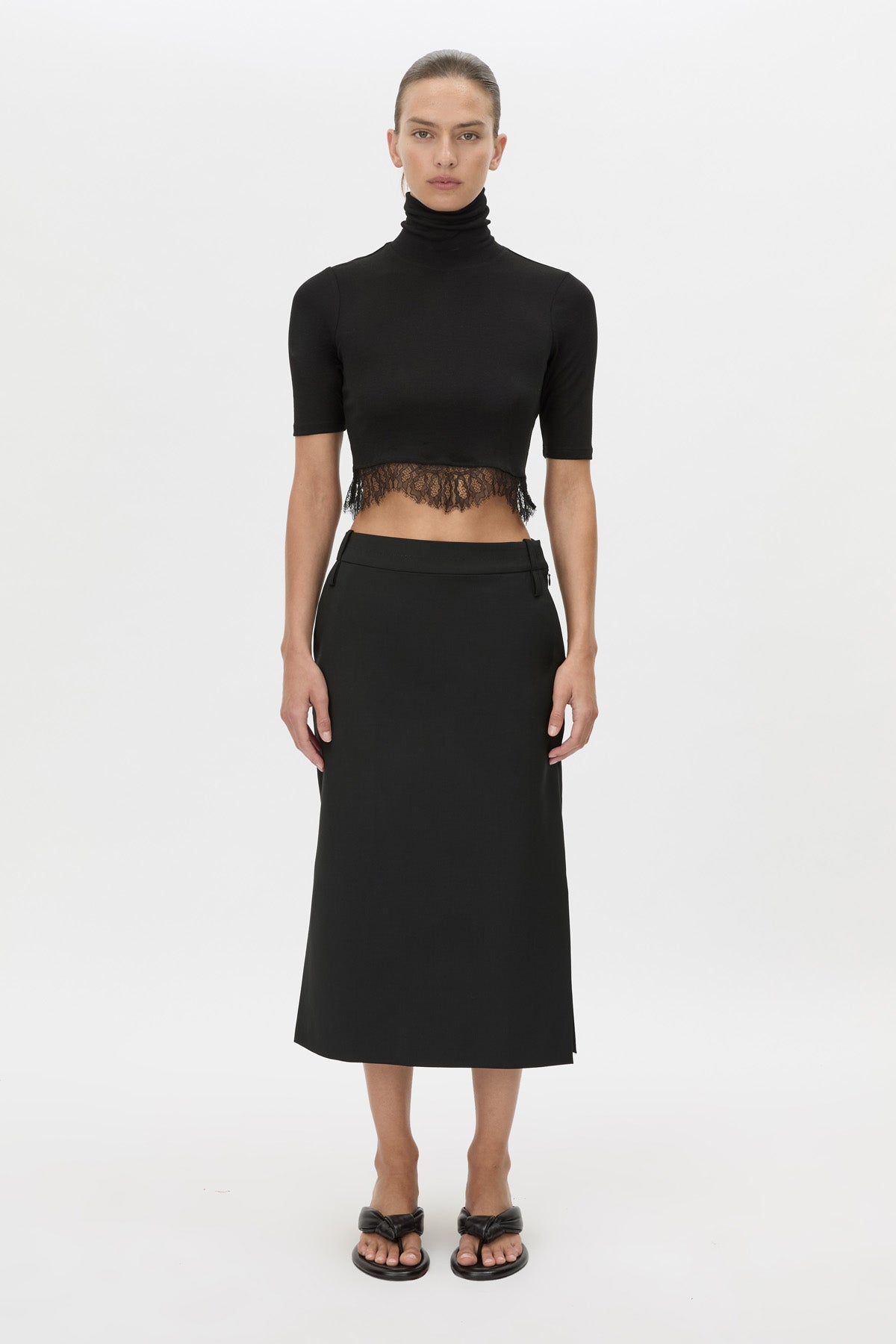 Front view CAMILLA AND MARC Chiaro Midi Skirt in black with low‑rise fit.