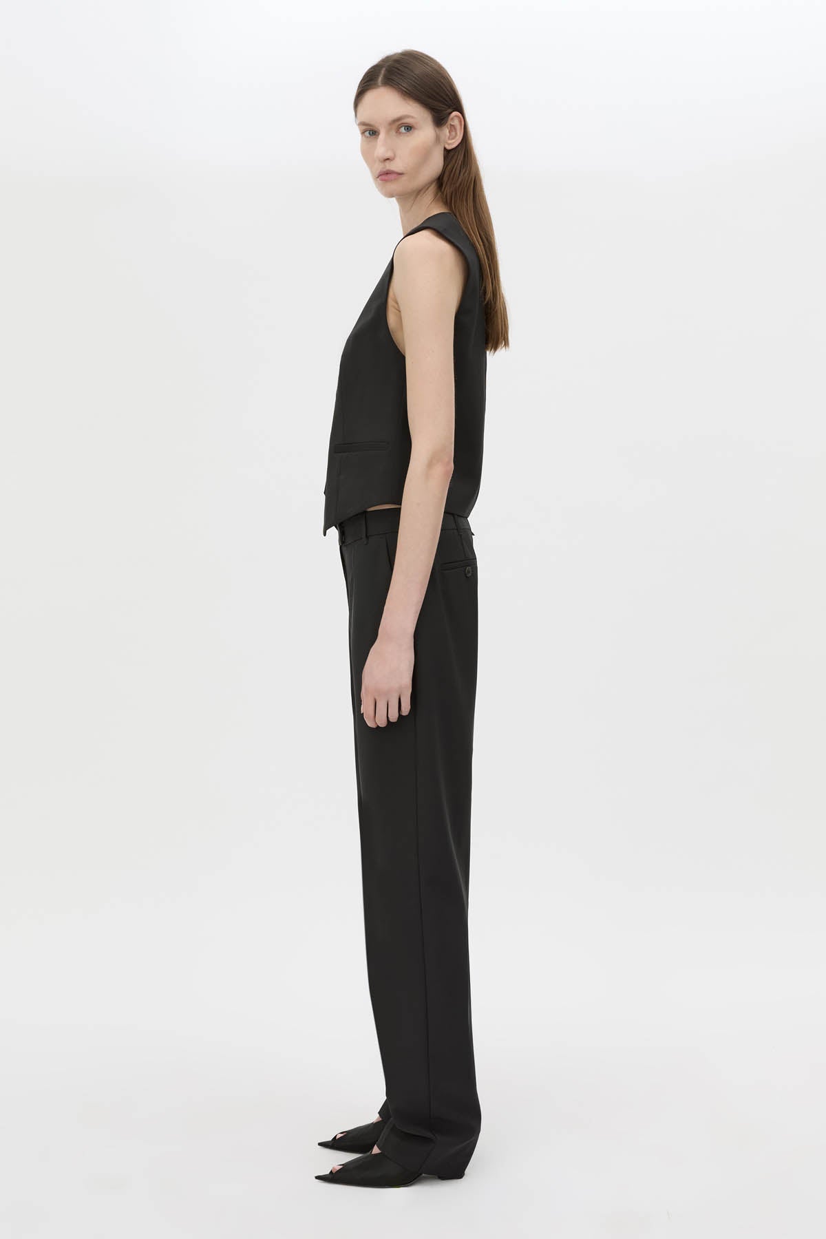 Side view CAMILLA AND MARC Chiaro Fitted Vest in black with double‑breasted closure.