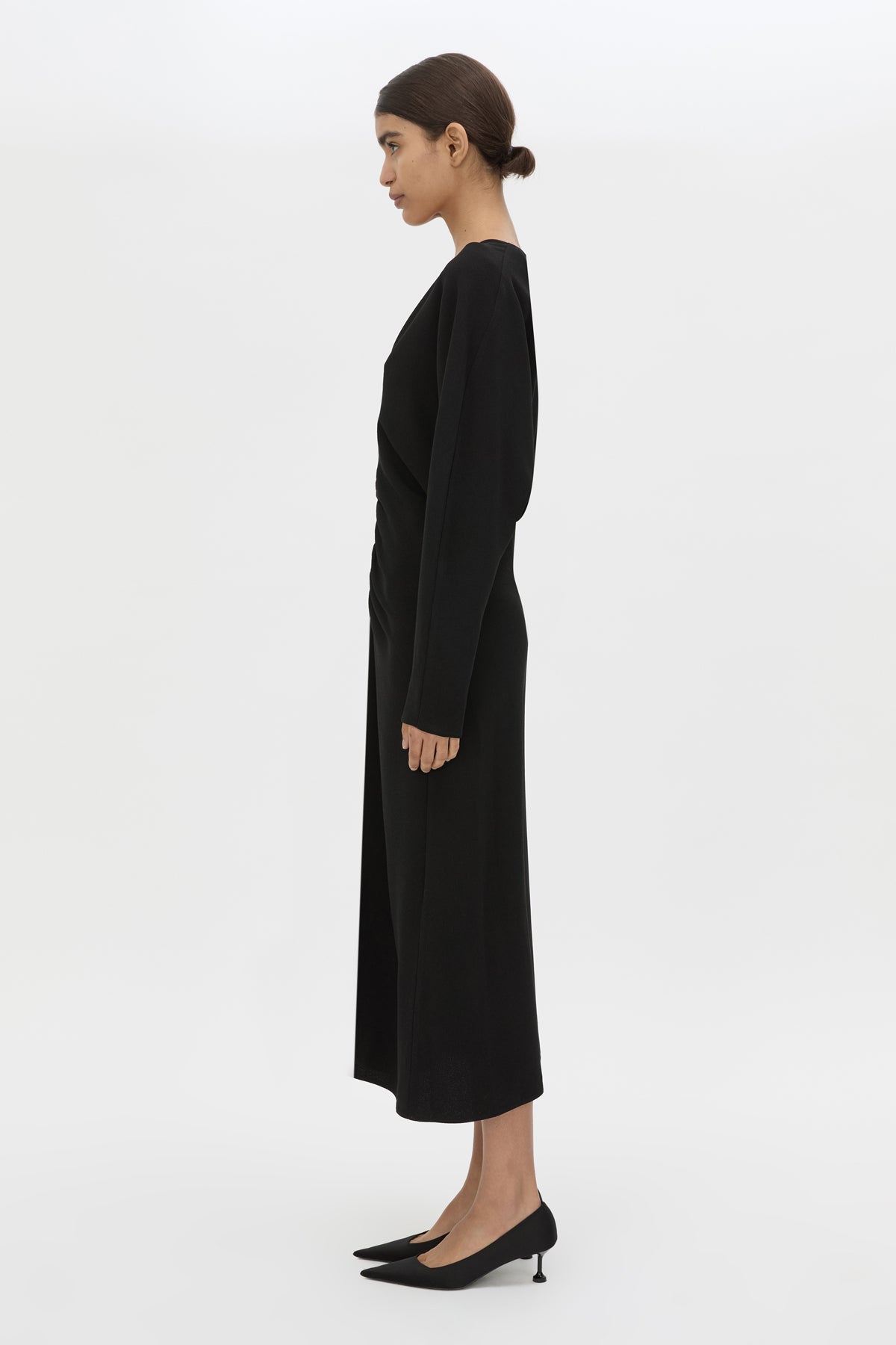 Side view CAMILLA AND MARC Dune Draped Waist Midi Dress in Black with gathered waist detailing.
