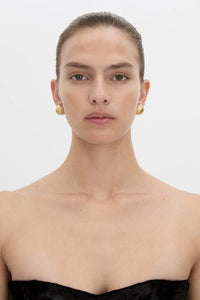 Front view CAMILLA AND MARC Eagan Earrings in gold with round semi‑sphere design and ruched texture.