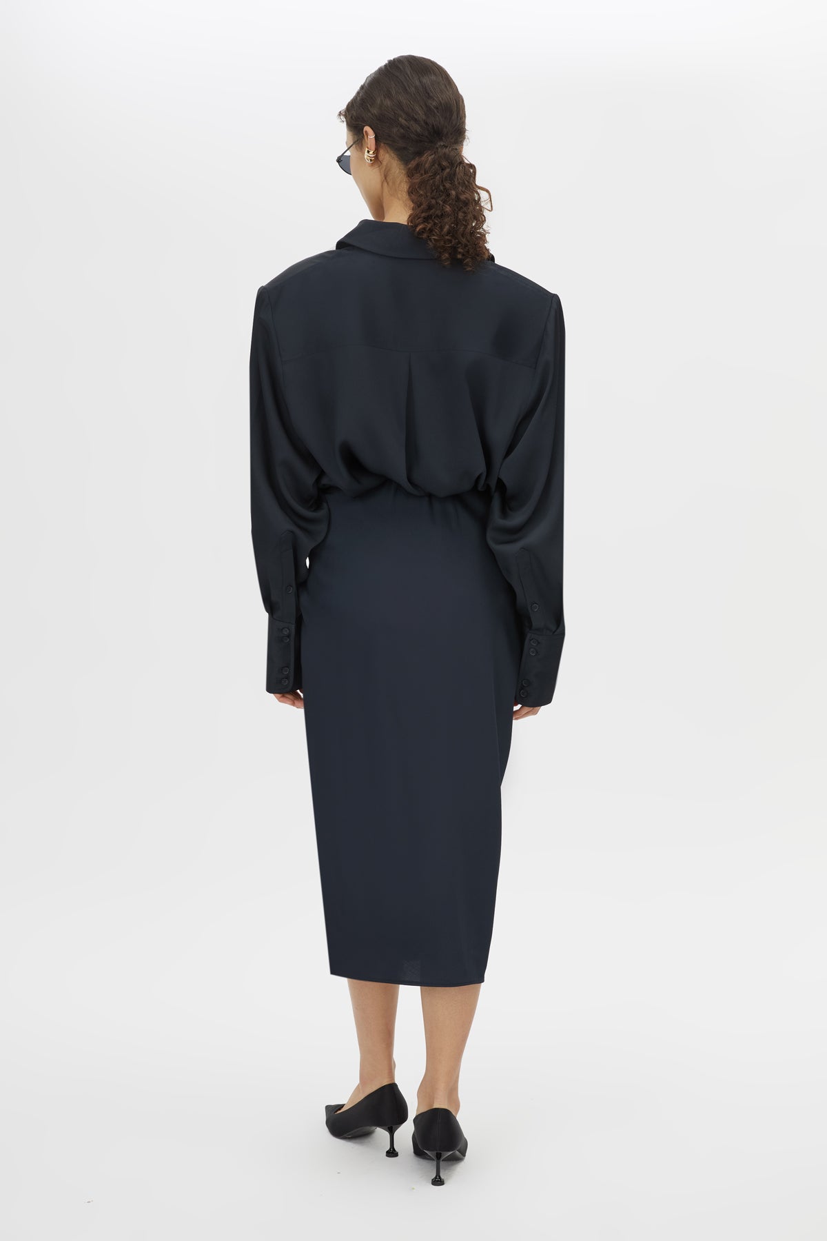 Back view CAMILLA AND MARC Elowyn Wrapped Midi Skirt in French Navy with front draped detailing.