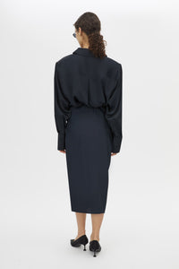 Back view CAMILLA AND MARC Elowyn Wrapped Midi Skirt in French Navy with front draped detailing.