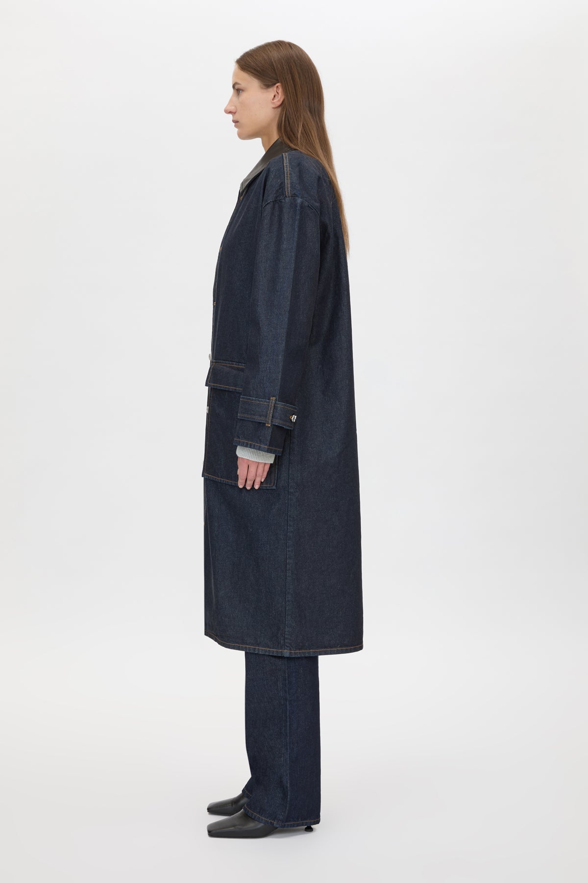 Side view CAMILLA AND MARC Enzo Denim Coat in Indigo Blue with a contrast leather collar and dual‑entry patch pockets.