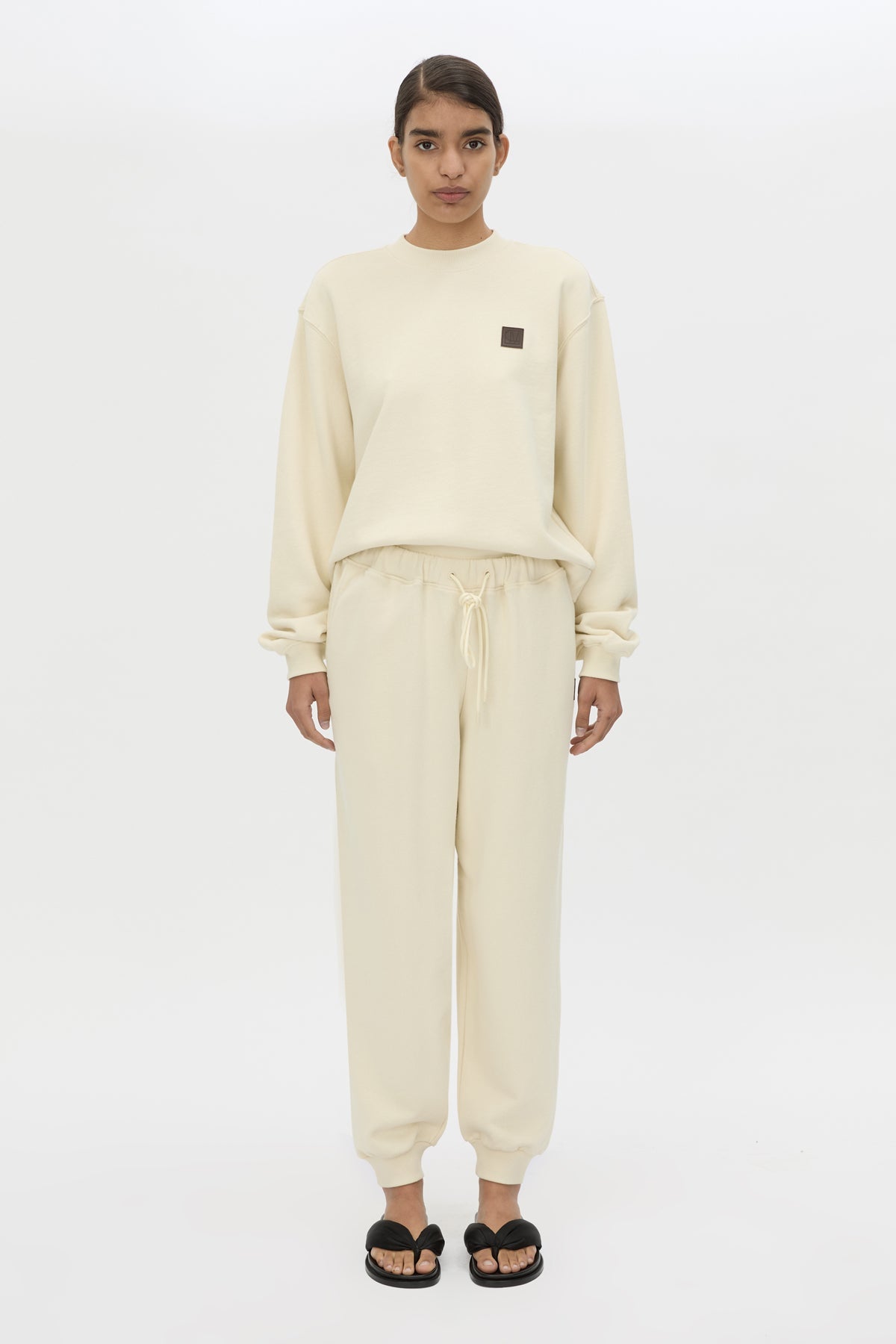 Front styled view CAMILLA AND MARC Idris Tracksuit Top in Ecru with folded rib crew neckline.