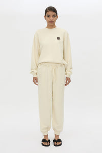 Front styled view CAMILLA AND MARC Idris Tracksuit Top in Ecru with folded rib crew neckline.