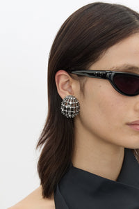 Three-quarter view CAMILLA AND MARC Jurien Cage Earrings in Silver with rhodium‑plated oval cage design.