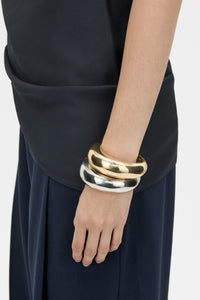 Styled view CAMILLA AND MARC Koa Cuff in sculptural 18k gold plating.  