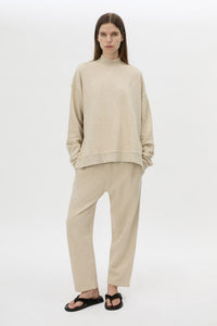 Front styled view CAMILLA AND MARC Lloyd Cropped Track Pant in cream with a straight leg and elasticated waist.