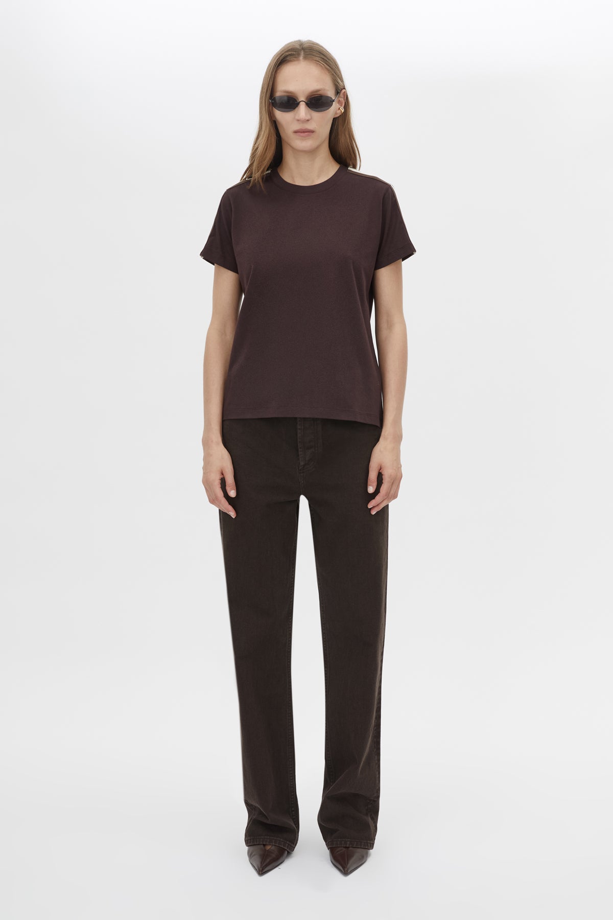 Front styled view CAMILLA AND MARC Locus Tee in Espresso with fitted baby‑tee silhouette and contrast stripe tape.  
