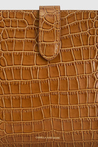 Cropped view CAMILLA AND MARC Mette Croc Clutch in tan croc‑embossed leather.