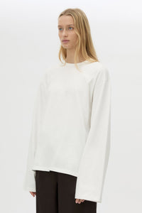 3/4 view CAMILLA AND MARC Peretti long sleeve tee in white with wide shaped sleeves and ribbed neckline.