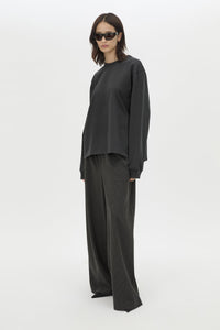 Front styled view CAMILLA AND MARC Studio Graphic Long Sleeve Top in Grey with boucle embroidered monogram.  