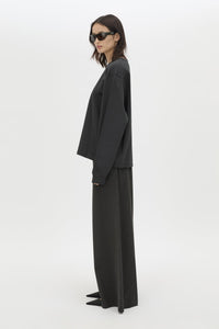 Side view CAMILLA AND MARC Studio Graphic Long Sleeve Top in Grey with boucle embroidered monogram.  