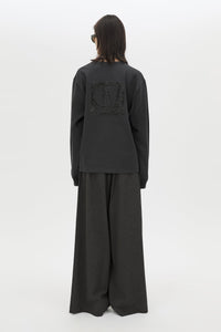 Back view CAMILLA AND MARC Studio Graphic Long Sleeve Top in Grey with boucle embroidered monogram.  
