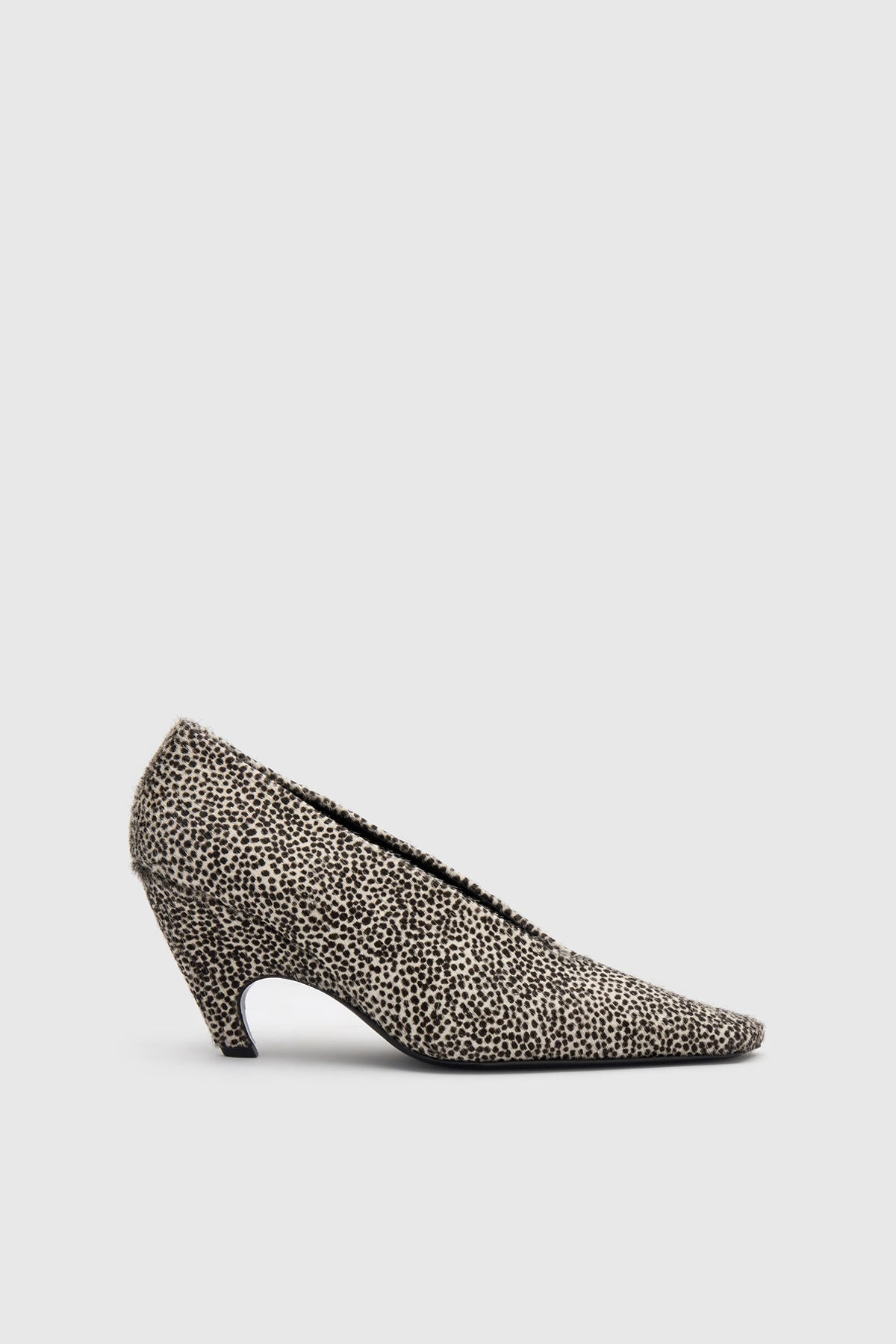 Side view CAMILLA AND MARC Wave Spotted Pump in Black and White with textured finish and angled heel.